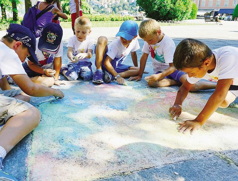 I bambini impegnati a decorare itratti di pavimentazione rovinata in piazza Duomoi<span xml:space=