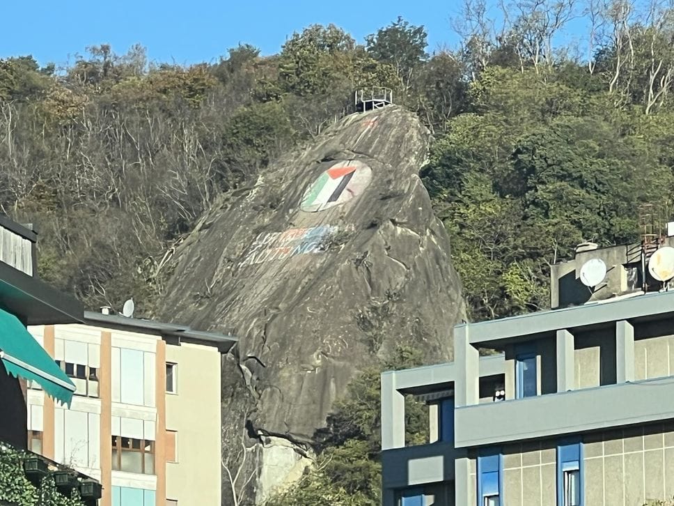 Bandiera palestinese sulla roccia della Spina Verde sopra piazza Camerlata