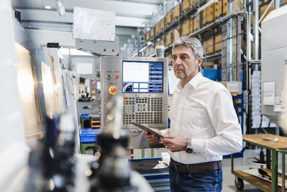 Businessman using tablet in production hall